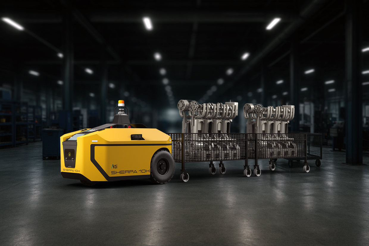Sherpa 10K in active tugging operation across factory floor